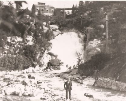 Original Plant with person standing in front of it historic photo